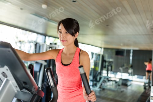 Preview: Woman running on Elliptical machine