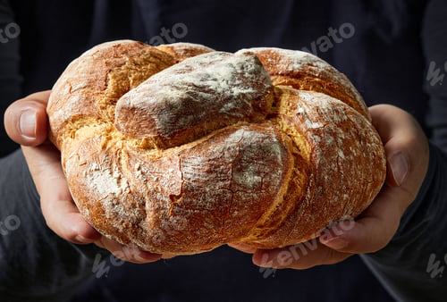 Preview: freshly baked bread in hands