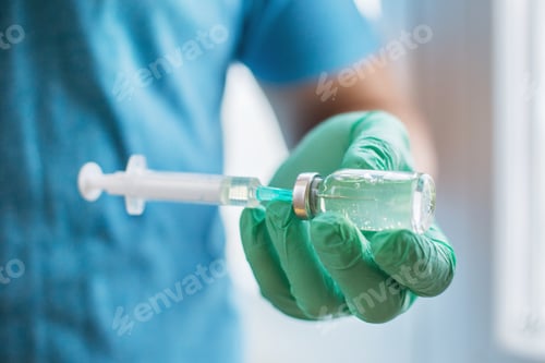 Preview: Hands of the doctor filling a syringe with vaccine.