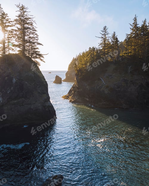 Preview: Golden hour at a serene coastal inlet surrounded by conifers
