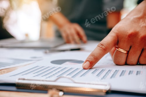 Preview: Two businessmen working with a digital tablet and make writing report on notebook.