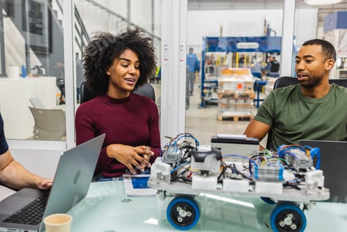 Preview: Engineers collaborating on robotics project in high tech factory