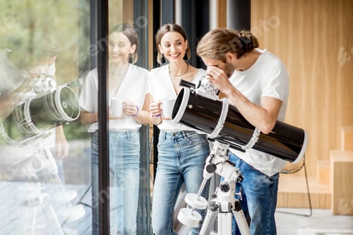 Preview: Couple with telescope at home