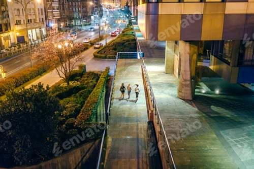 Preview: Women friends runners training together on the city at night