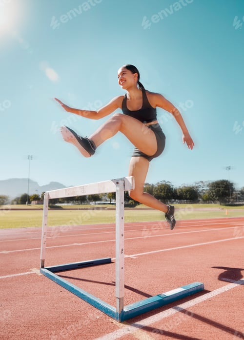 Preview: Fitness, hurdle and woman running in stadium track for training, health and sports workout. Exercis
