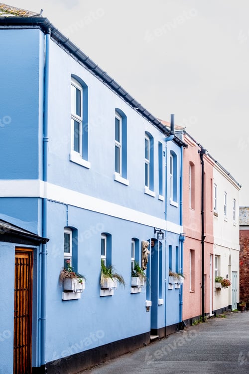 Preview: Vertical of colorful houses on the street on a cloudy day in Shaldon, Devon