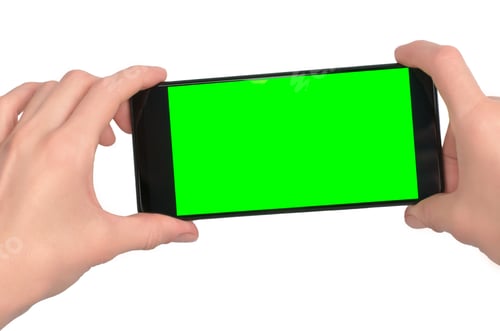 Preview: Smartphone with blank green display in female hands isolated on white background, close-up.
