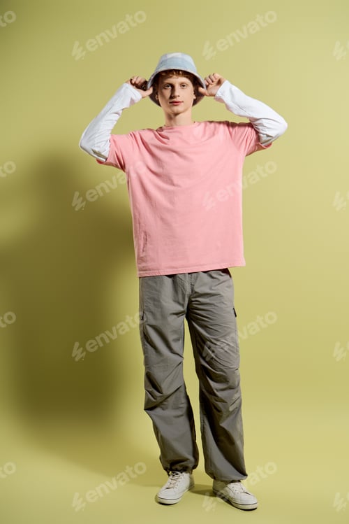 Preview: Handsomeness shines through stylish young mans trendy outfit against a vibrant backdrop