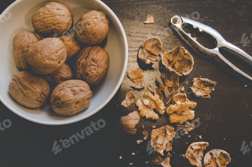Preview: Walnuts in a white bowl on a black table