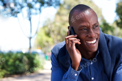Preview: african american businessman talking on cell phone outdoors