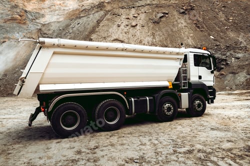 Preview: Dumper trucks unloading gravel on highway construction site