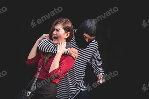 Preview: Thief threatening with knife, young woman scared and screaming while arrested by bandit.