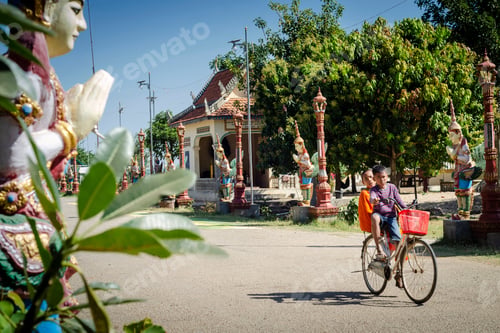 Preview: children cycling at wat svay andet temple gardens in cambodia