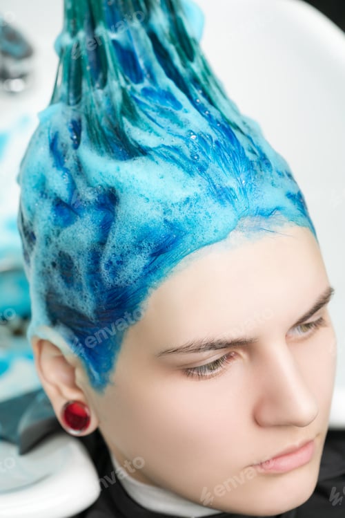 Preview: Head of Young Woman with Blue Hair While Shampooing Head in Hair Salon After Dyeing