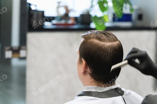 Preview: Visit to barbershop.Young stylish man,businessman makes fashionable haircut,hairdress.Barber stylist
