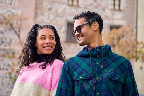 Preview: Happy tourist couple smiling and walking in urban city