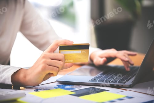 Preview: girl holding a credit card and using a laptop Business woman working from home . online shopping, ec