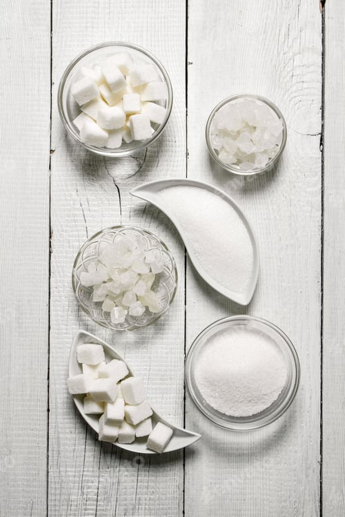 Preview: Refined sugar, sand, and crystalline. On white wooden background.