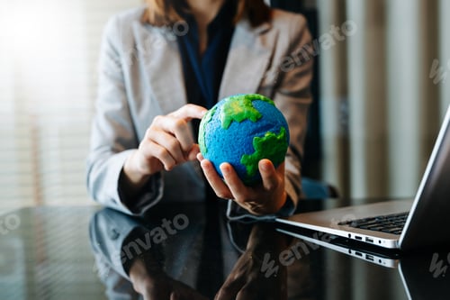 Preview: A professional holds a model Earth, symbolizing global awareness, eco responsibility