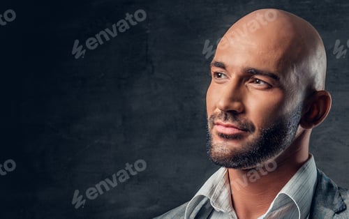 Preview: Positive shaved head male dressed in a grey suit.