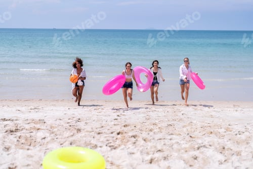 Preview: Teenage girl friendship enjoy laughing play on the blue sky sea and run to get water inflation toy