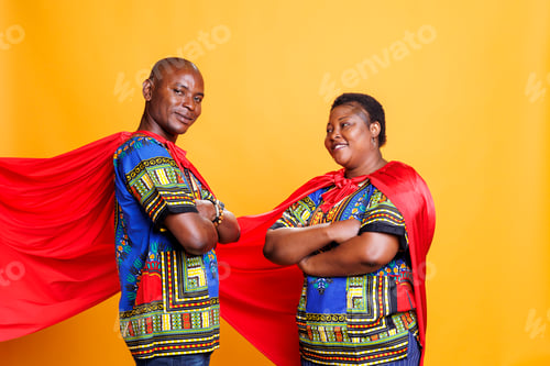 Preview: Couple wearing superhero capes portrait