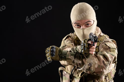 Preview: front view of young soldier in uniform with gun on black background israel warrior