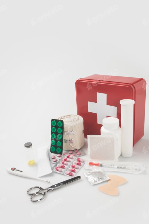 Preview: first-aid kit with blister packs with pills, thermometer and elastic bondage isolated on white
