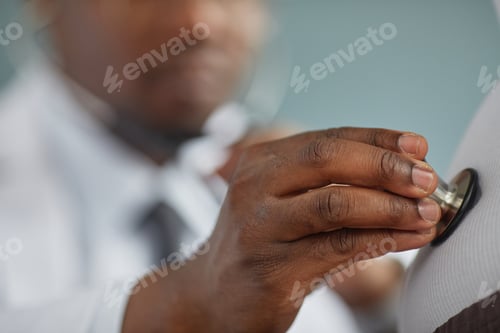 Preview: Middle Aged Black Man Using Stethoscope Examining Patient in Clinic