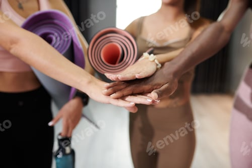 Preview: Sportswomen Stacking Hands