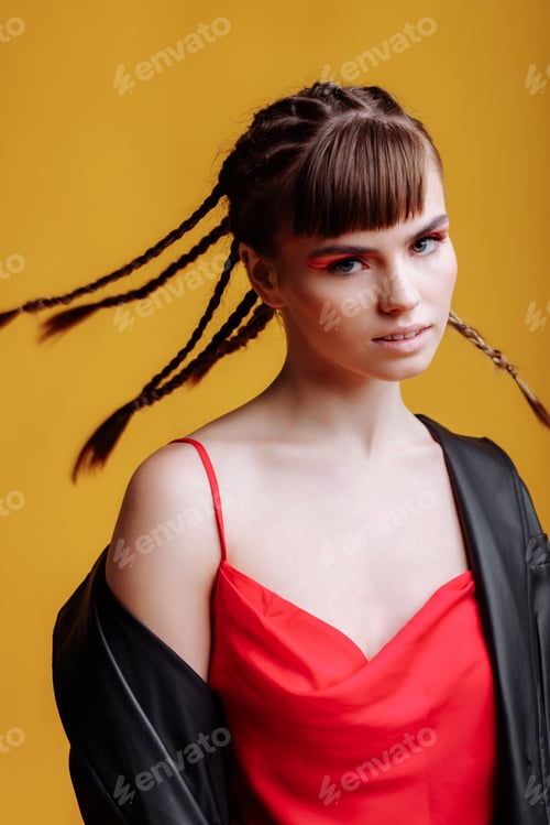 Preview: Beautiful female model in a red dress yellow background
