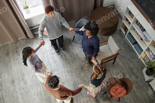 Preview: Top Down View at Diverse Group of Teenagers Standing in Circle