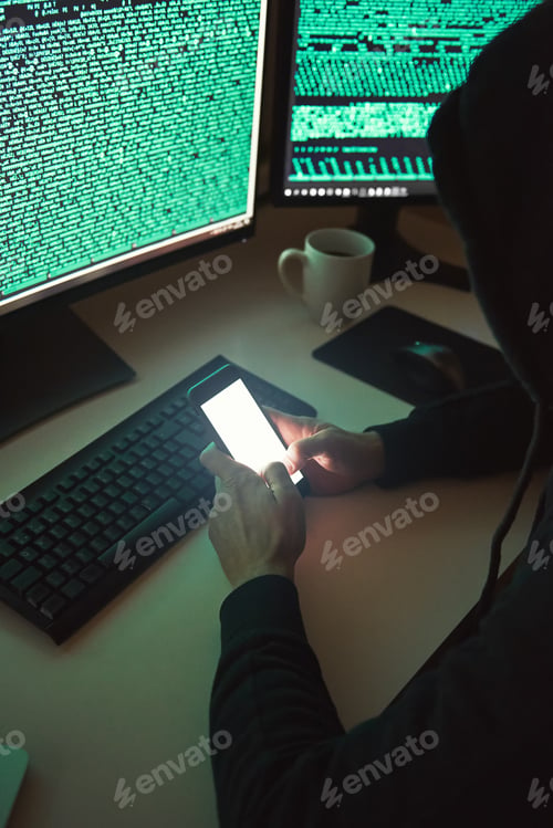Preview: Personal information. Vertical photo of young hacker in black hoodie using multiple computers and