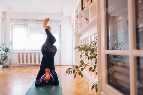 Preview: Dark haired girl doing headstand with eagle legs while balancing and enjoying.