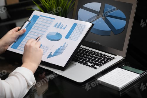 Preview: Businessman analyzing investment charts with laptop. Accounting