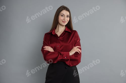 Preview: Woman in Red Blouse Posing With Arms Crossed