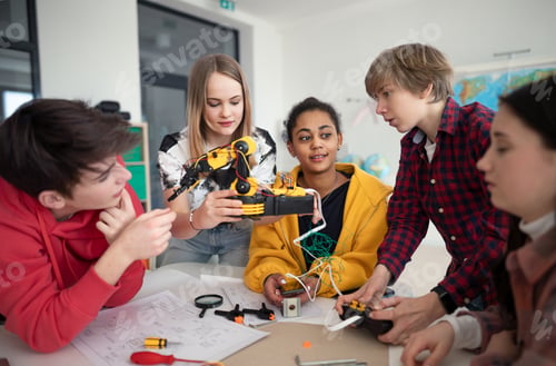 Preview: Group of students building and programming electric toys and robots at robotics classroom
