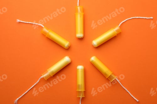 Preview: Women tampons on orange background, top view