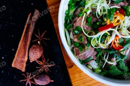 Preview: High angle close up of a bowl of beef pho.