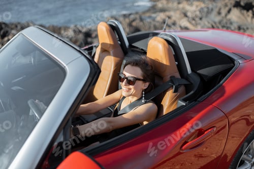 Preview: Woman driving a cabriolet on a summer time