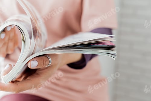 Preview: Young woman with a booklet with blank pages
