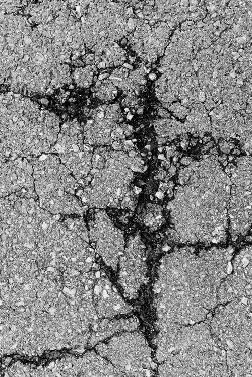 Preview: cropped background texture of rough Cracked asphalt.
