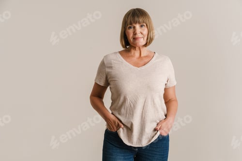 Preview: Senior blonde woman in t-shirt posing and looking at camera