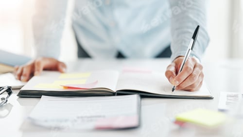 Preview: Closeup, hands and notebook for planning, writing and calendar for schedule, deadline and new proje