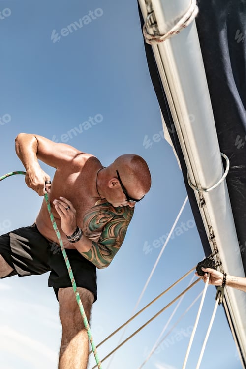Preview: Handsome Man Working on Sailboat