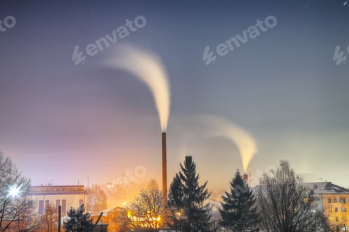 Preview: View of working heat station with steam from the pipe at night over the city.