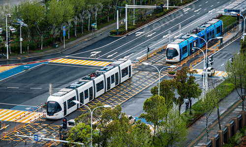 Preview: a couple of trams sitting on top of an asphalt street