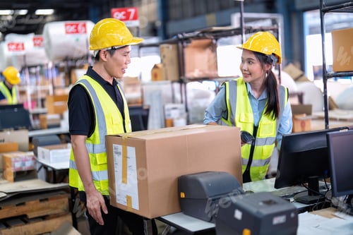 Preview: 2 Staff working in large depot storage warehouse check packing box and scan at cashier counter
