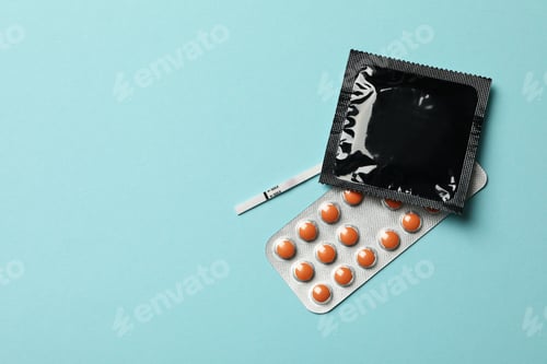 Preview: Pregnancy test, condom and pills on blue background