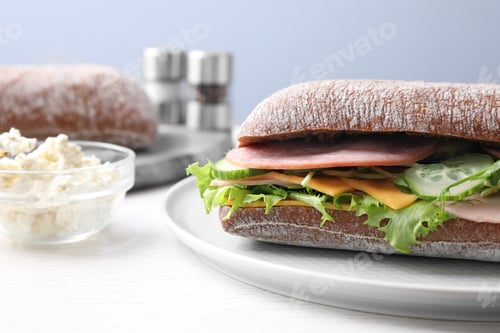 Preview: Tasty sandwich with ham on white wooden table, closeup